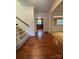 Foyer with hardwood floors and staircase, with view into Kitchen and Dining Area at 6117 Yellowood Rd, Charlotte, NC 28210