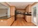 Open kitchen features wood floors, granite countertops, and stainless steel appliances at 6117 Yellowood Rd, Charlotte, NC 28210