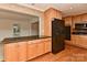 Spacious kitchen featuring wood floors, ample cabinet space, and black appliances at 6117 Yellowood Rd, Charlotte, NC 28210
