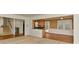 Bright and airy living room with hardwood and carpeted flooring, connecting to kitchen area at 6117 Yellowood Rd, Charlotte, NC 28210