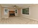 Living room features a brick fireplace, three windows, and tan walls at 6117 Yellowood Rd, Charlotte, NC 28210