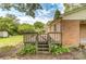 Wooden back deck accessible by stairs, offering a private outdoor space surrounded by greenery and natural light at 617 Oak Grove Rd, Kings Mountain, NC 28086