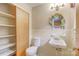Practical bathroom featuring a toilet, sink, shelving and closet, designed for functionality and comfort at 617 Oak Grove Rd, Kings Mountain, NC 28086