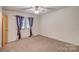 Neutral carpeted bedroom with a window and ceiling fan at 617 Oak Grove Rd, Kings Mountain, NC 28086