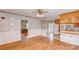 Cozy dining area featuring wood floors, painted paneled walls, ceiling fan, and open access to other rooms at 617 Oak Grove Rd, Kings Mountain, NC 28086