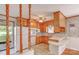 Well-lit kitchen with wooden cabinets, white appliances and retro bar at 617 Oak Grove Rd, Kings Mountain, NC 28086