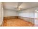 Bright and airy living room featuring wood-look floors, paneled walls and a ceiling fan at 617 Oak Grove Rd, Kings Mountain, NC 28086