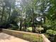 Expansive back deck overlooking wooded area with mature trees and lush landscaping at 62 Fairway Rdg, Clover, SC 29710