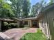 Charming single-story home with a brick driveway and mature trees surrounding the property at 62 Fairway Rdg, Clover, SC 29710