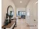 Welcoming foyer featuring light wood floors, stylish console table, decorative mirror, and an open view into the living area at 6346 Fairfax Ct, Maiden, NC 28650