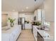 Modern all-white kitchen featuring stainless steel appliances, an island with a quartz countertop, and ample cabinet space at 6346 Fairfax Ct, Maiden, NC 28650