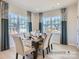 Bright dining area with a wooden table, seating for six, and windows offering community views at 6352 Fairfax Ct, Maiden, NC 28650