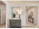 Stylish entryway with a decorative dresser, modern lamp, neutral wall colors, and view into the home at 6352 Fairfax Ct, Maiden, NC 28650