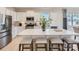 Bright kitchen featuring white cabinets, stainless steel appliances, a large island with seating, and pendant lights at 6352 Fairfax Ct, Maiden, NC 28650