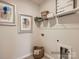 Laundry room with open shelving, space for appliances, and decorative artwork for a functional space at 6352 Fairfax Ct, Maiden, NC 28650