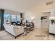 Comfortable living room featuring stylish decor, a neutral sofa, and ample natural light from multiple windows at 6352 Fairfax Ct, Maiden, NC 28650