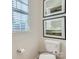 Powder room featuring neutral walls, modern artwork, and a toilet with classic fixtures at 6352 Fairfax Ct, Maiden, NC 28650