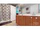 Bathroom with double vanity, shower with patterned curtain, and linen closet at 725 Chelton Ln, Fort Mill, SC 29715