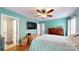 Bright bedroom with a ceiling fan, hardwood floors, and adjacent bathroom at 725 Chelton Ln, Fort Mill, SC 29715