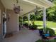 Inviting covered patio with hanging flower baskets and ample space for outdoor entertaining and relaxing at 725 Chelton Ln, Fort Mill, SC 29715