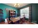 This dining room has wood floors, stylish curtains, and a large window at 725 Chelton Ln, Fort Mill, SC 29715