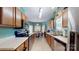 Bright kitchen featuring wooden cabinets, stainless steel appliances, and a view to the eat-in area at 725 Chelton Ln, Fort Mill, SC 29715