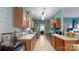 Galley style kitchen with wood cabinets, stainless appliances and a view to the dining room at 725 Chelton Ln, Fort Mill, SC 29715