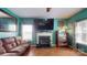 Comfortable living room with fireplace, large screen television and hardwood style floors at 725 Chelton Ln, Fort Mill, SC 29715