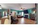 Inviting living room featuring a fireplace, TV, and hardwood floors at 725 Chelton Ln, Fort Mill, SC 29715