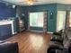 Inviting living room with a fireplace, wooden floors, and lots of natural light at 725 Chelton Ln, Fort Mill, SC 29715