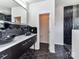 Modern bathroom showcasing dual vessel sinks, black hexagon tile floors, and striking black and white accents at 7518 Turley Ridge Ln, Charlotte, NC 28273