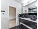 Modern bathroom boasting dual vessel sinks, black hexagon tile floors, and sleek black and white decor at 7518 Turley Ridge Ln, Charlotte, NC 28273