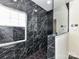 Modern bathroom showcasing a luxurious shower with black marble-like tile and sleek fixtures at 7518 Turley Ridge Ln, Charlotte, NC 28273