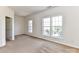 Spacious carpeted bedroom with three windows, providing ample natural light and backyard views at 7518 Turley Ridge Ln, Charlotte, NC 28273
