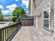 A wooden deck with a privacy screen provides outdoor living space with views of the surrounding neighborhood at 7518 Turley Ridge Ln, Charlotte, NC 28273