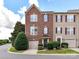 Charming brick townhome featuring an attached garage and manicured landscaping at 7518 Turley Ridge Ln, Charlotte, NC 28273