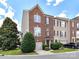Charming brick townhome featuring an attached garage and manicured landscaping at 7518 Turley Ridge Ln, Charlotte, NC 28273
