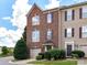 Charming brick townhome featuring an attached garage and manicured landscaping at 7518 Turley Ridge Ln, Charlotte, NC 28273