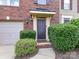 Close-up of front door with brick entryway and well-maintained landscaping at 7518 Turley Ridge Ln, Charlotte, NC 28273