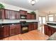 Stylish kitchen showcasing dark cabinetry, granite counters, and modern stainless steel appliances at 7518 Turley Ridge Ln, Charlotte, NC 28273