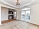 View of the spacious living room with windows, tray ceilings, and an office space in the background at 7518 Turley Ridge Ln, Charlotte, NC 28273