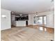 Open-concept living room with hardwood floors, adjoining kitchen, and lots of natural light at 7518 Turley Ridge Ln, Charlotte, NC 28273
