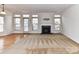Bright living room featuring a fireplace, ample natural light from large windows, and plush carpeting at 7518 Turley Ridge Ln, Charlotte, NC 28273