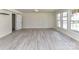 Spacious living room featuring light wood-look floors and natural light at 7518 Turley Ridge Ln, Charlotte, NC 28273