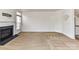 Spacious living room with a cozy fireplace and lots of natural light from large windows at 7518 Turley Ridge Ln, Charlotte, NC 28273