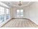 Bright living room with decorative tray ceiling and large windows filling the space with natural light at 7518 Turley Ridge Ln, Charlotte, NC 28273