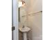 A well-lit powder room with a pedestal sink, oval mirror, and towel rack at 7518 Turley Ridge Ln, Charlotte, NC 28273