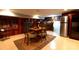 Basement dining with a wood-paneled bar, wine storage, and a refrigerator at 802 E Franklin St, Monroe, NC 28112