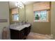 Bathroom features a single vanity, tile floors and a large mirror, offering style and function at 802 E Franklin St, Monroe, NC 28112