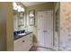 Charming bathroom featuring a single vanity with a black countertop and plenty of storage space at 802 E Franklin St, Monroe, NC 28112